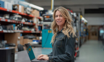 Female at laptop in bodyshop